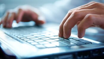 Close-up of typing male hands