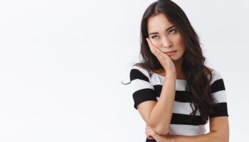 Girl cant stand long talks, wanna escape from boring meeting. Annoyed and bored fed up asian female, facepalm and roll eyes bothered, standing uninterested and dissatisfied over white background